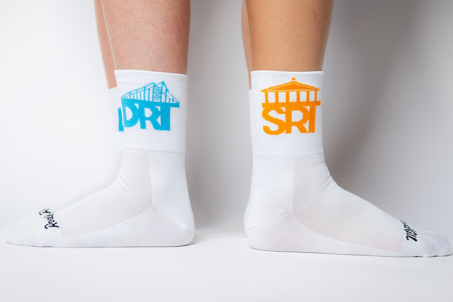White socks with blue and orange logos on a white background